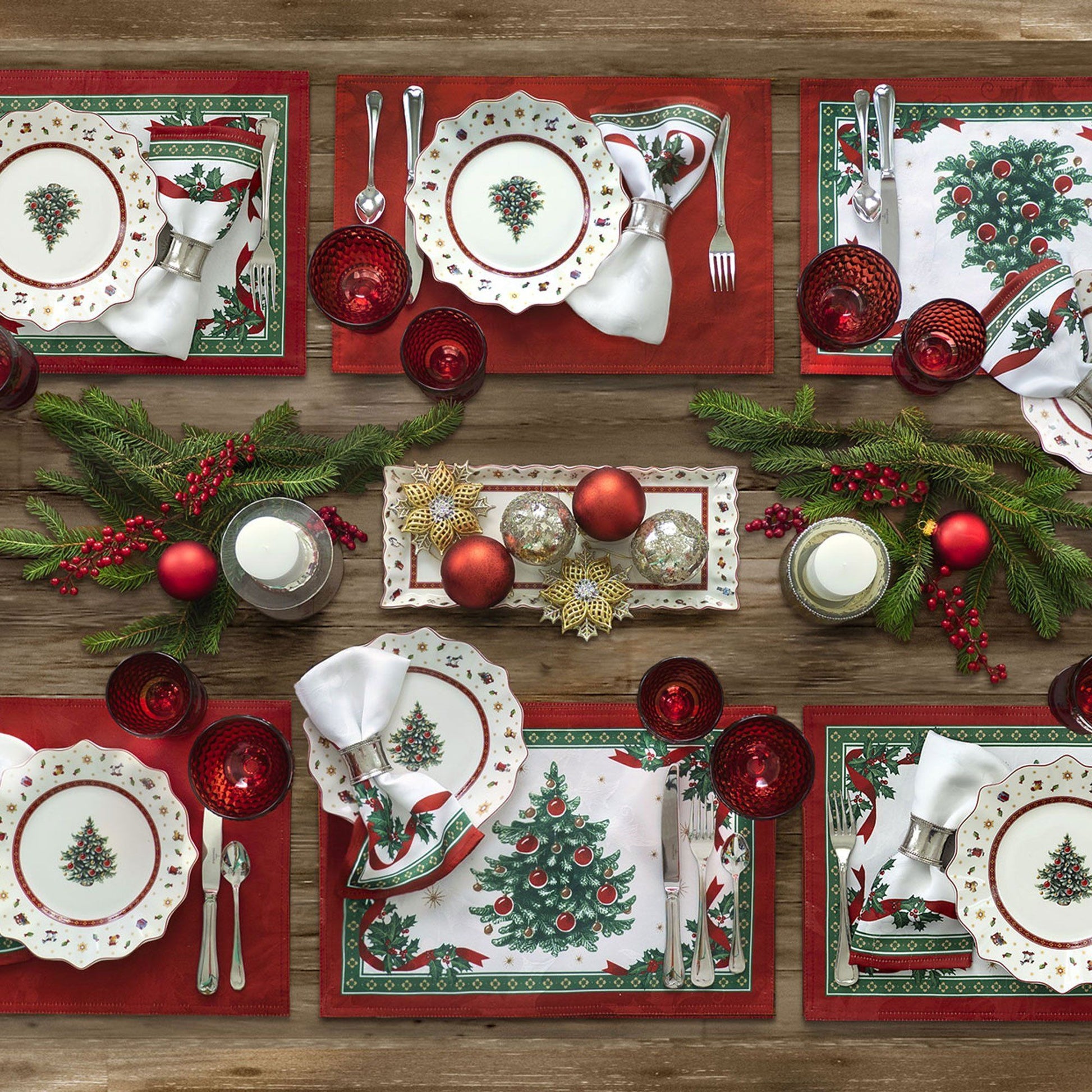 White holly damasks napkin set of 4 with red/green border and red ribbon design trim with holly sprigs on table