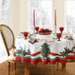 White holiday tablecloth with holly damask designs all over, red ribbon design border and red and green holly and Christmas trees along the ribbon border - round table