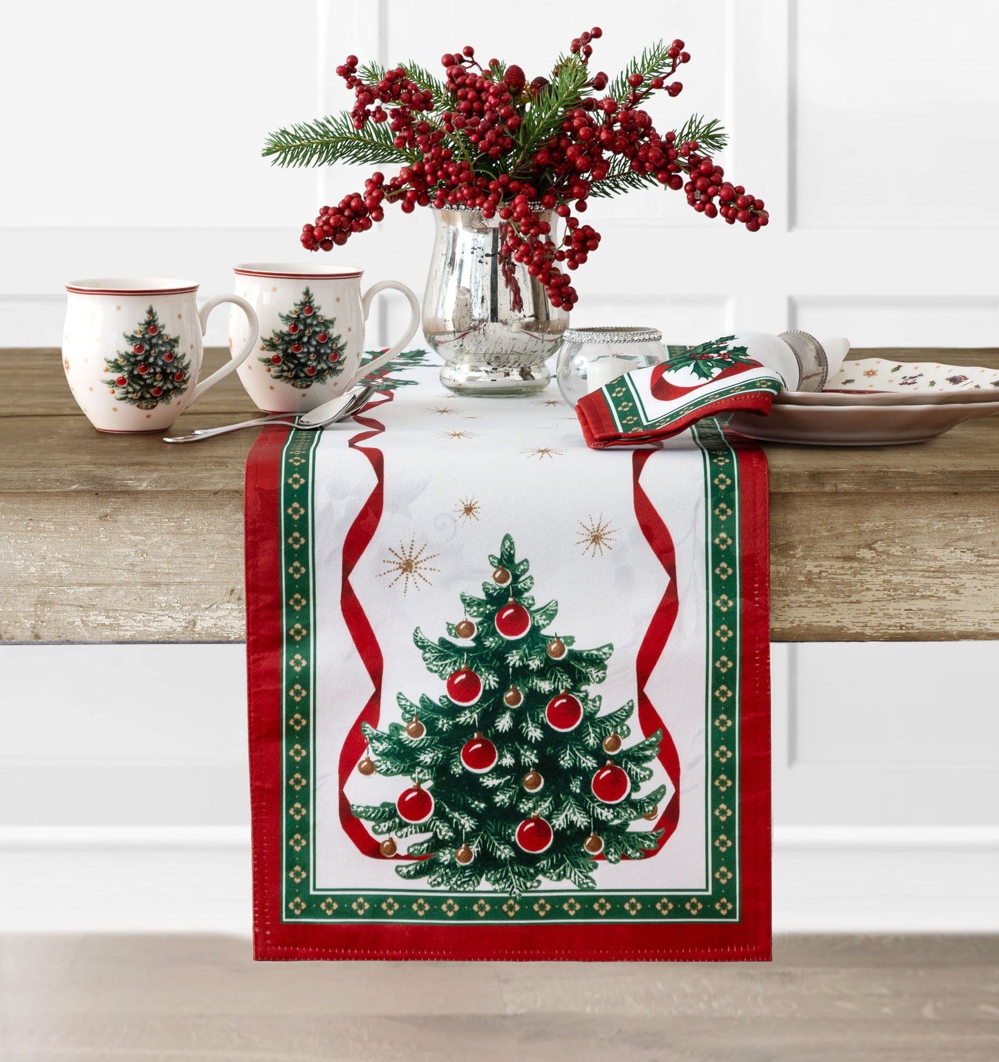 White holly damask runner with a Christmas tree design on each end. Entire runner is bordered in red/green and red ribbon design with holly sprigs.